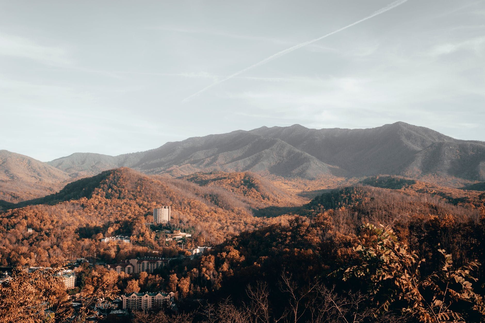 Autumn foliage blankets the hills and ridges leading up to the Great Smoky Mountains overlooking Gatlinburg.